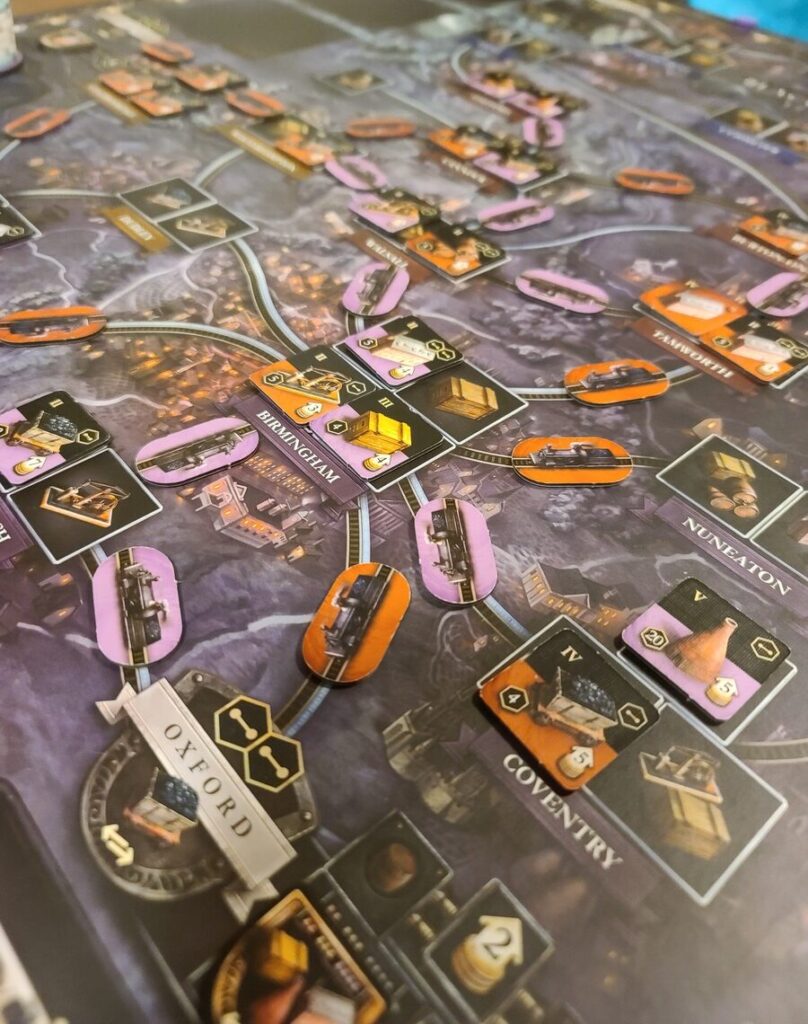 Brass: Birmingham play example where orange player and purple player have both built extensive networks around the Birmingham location