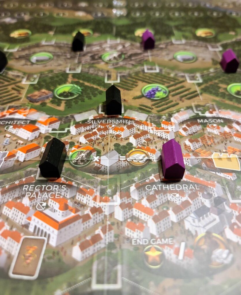Ragusa game board city hex spaces showing two black houses and one purple house on the Silversmith hex