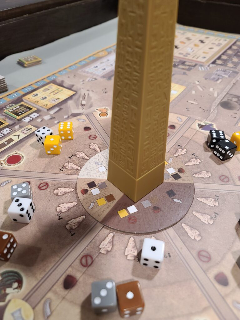 Obelisk showing pure, tainted, and forbidden dice around the wheel